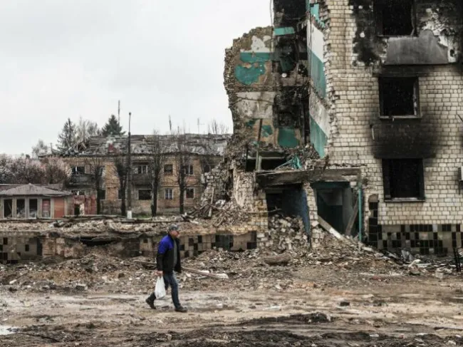 A Ukrainian walks through the ruins of Borodyanka near Kyiv on April 22, 2023.